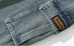 Close-up of a blue denim pocket with a brand label on a white background