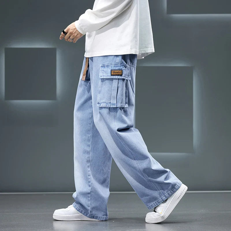 Light blue cargo pants worn by a person on a gray background