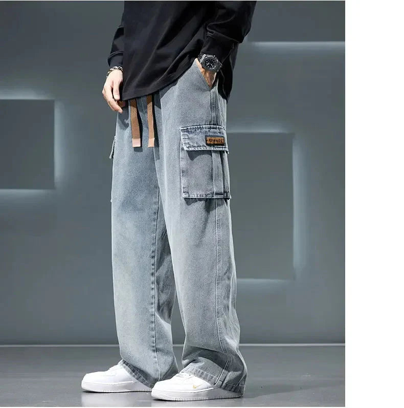 Person wearing light blue cargo pants with multiple pockets in a neutral setting