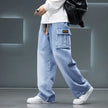 Person wearing light blue cargo pants with a gray background