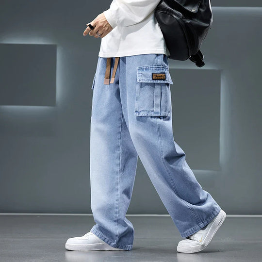 Person wearing light blue cargo pants with a gray background