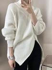 Person wearing a white sweater with a blurred background