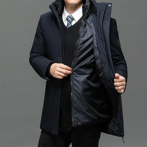 Person wearing a black coat with a gray background