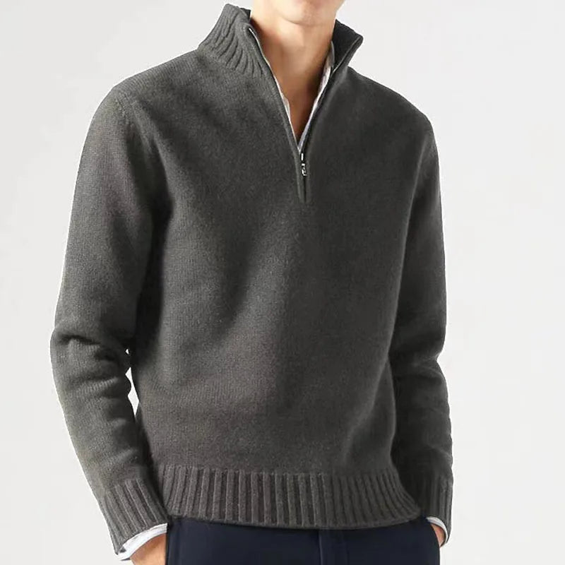 Gray half-zip sweater worn by a person on a light gray background