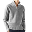 Gray half-zip sweater worn by a person on a white background