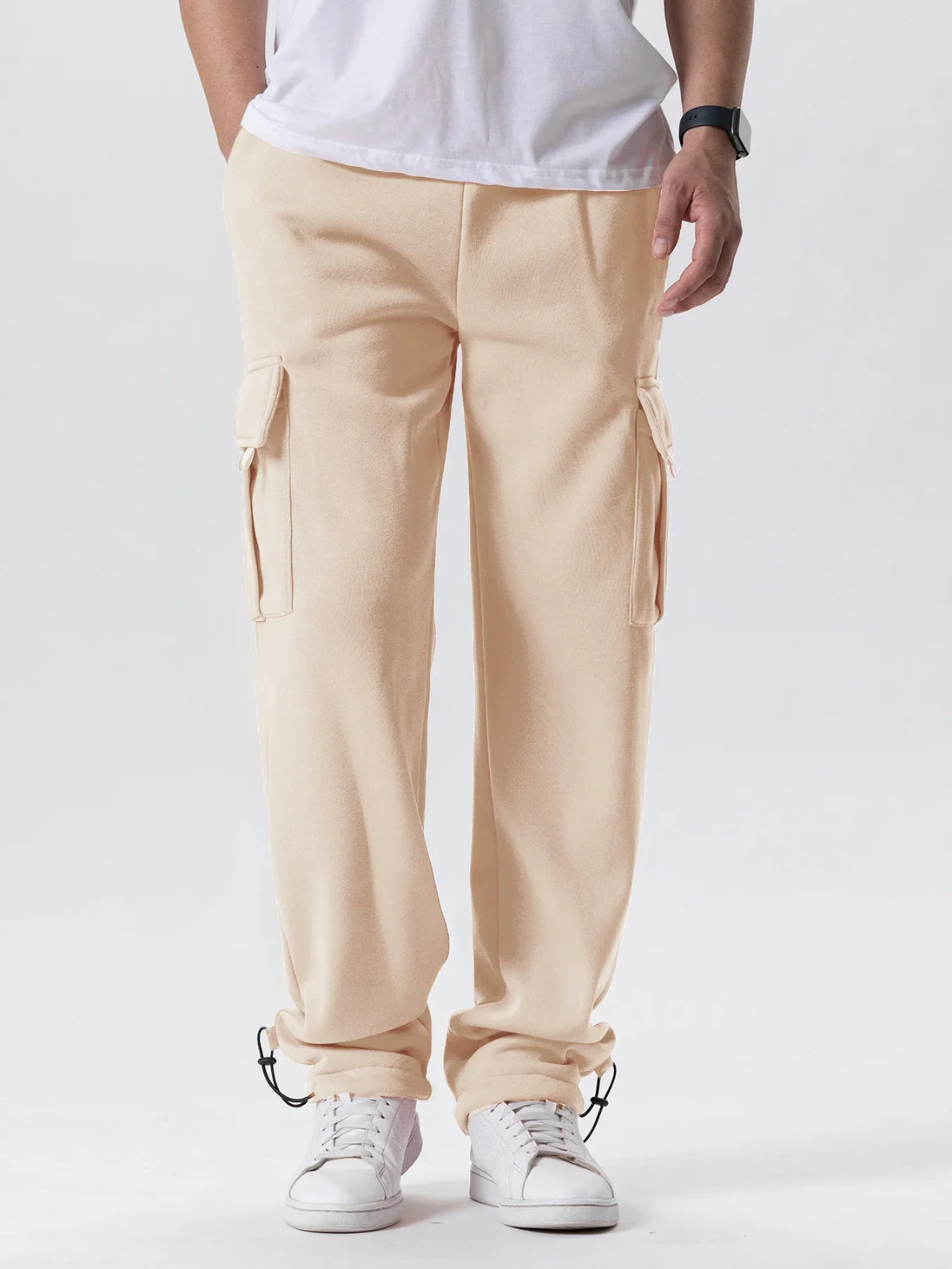 Person wearing beige cargo pants on a white background