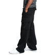 Person wearing black cargo pants on a white background