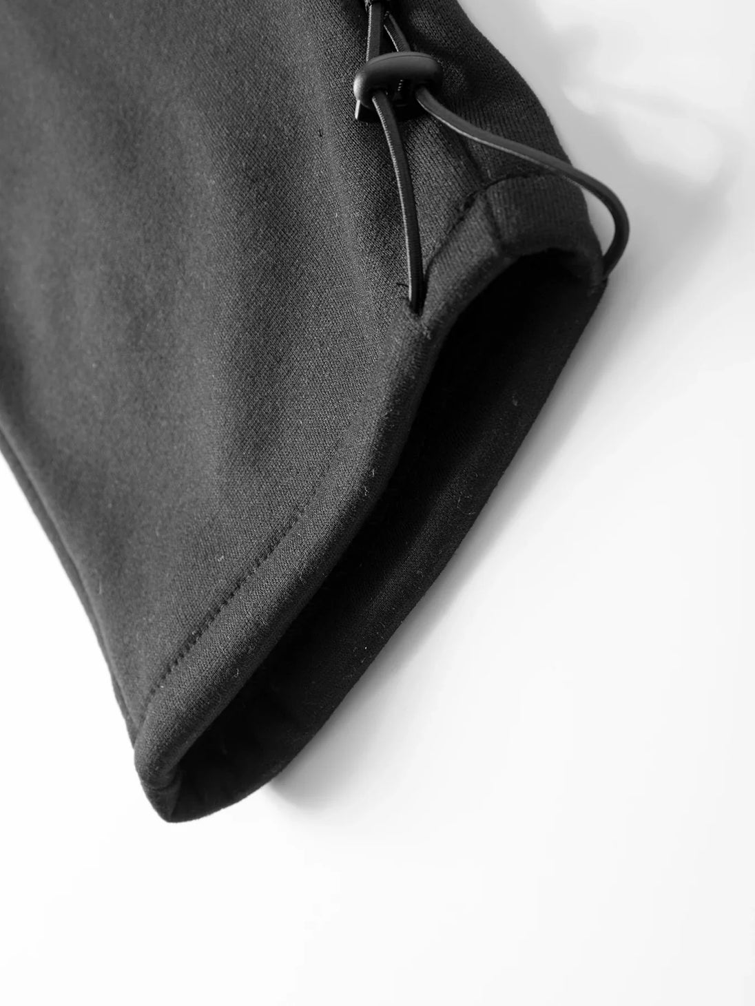 Close-up of a black glove on a white background