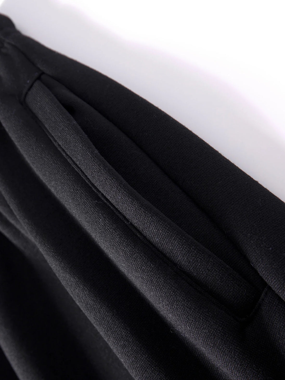 Close-up of black fabric with a white background
