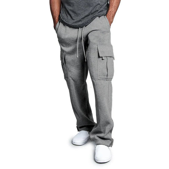 Person wearing gray cargo pants on a white background