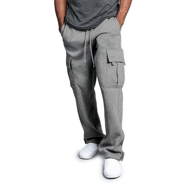 Person wearing gray cargo pants on a white background
