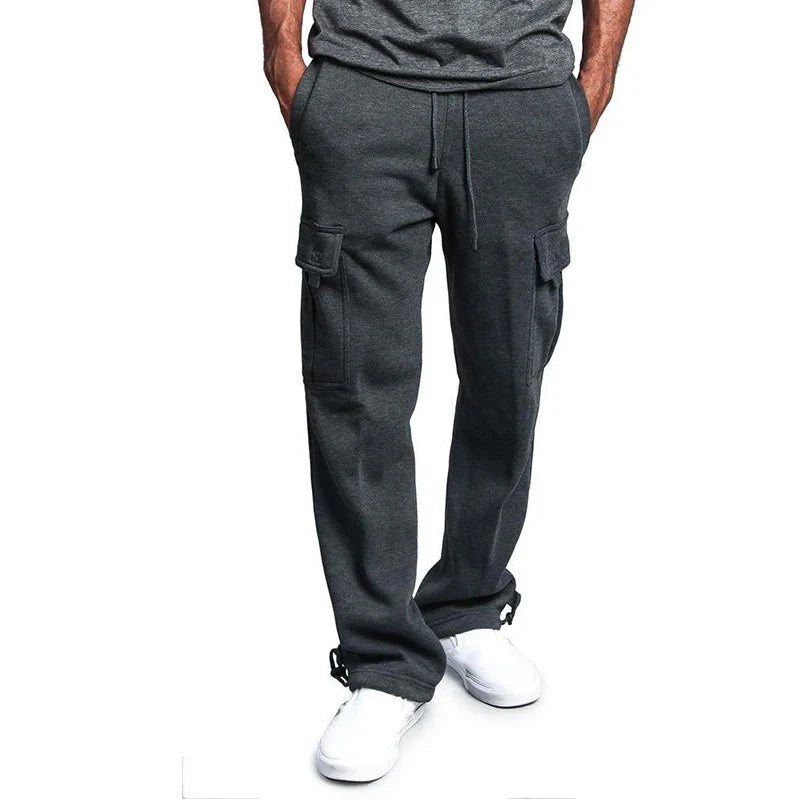 Person wearing gray cargo pants on a white background