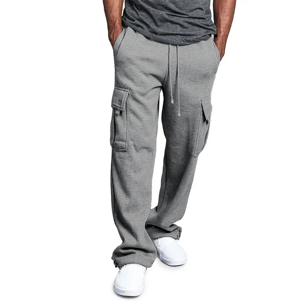 Person wearing gray cargo sweatpants on a white background