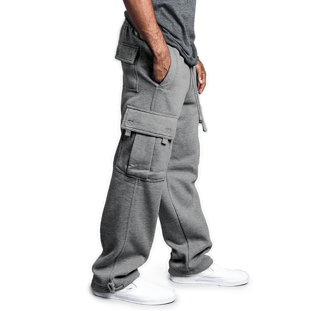 Person wearing gray cargo pants on a white background