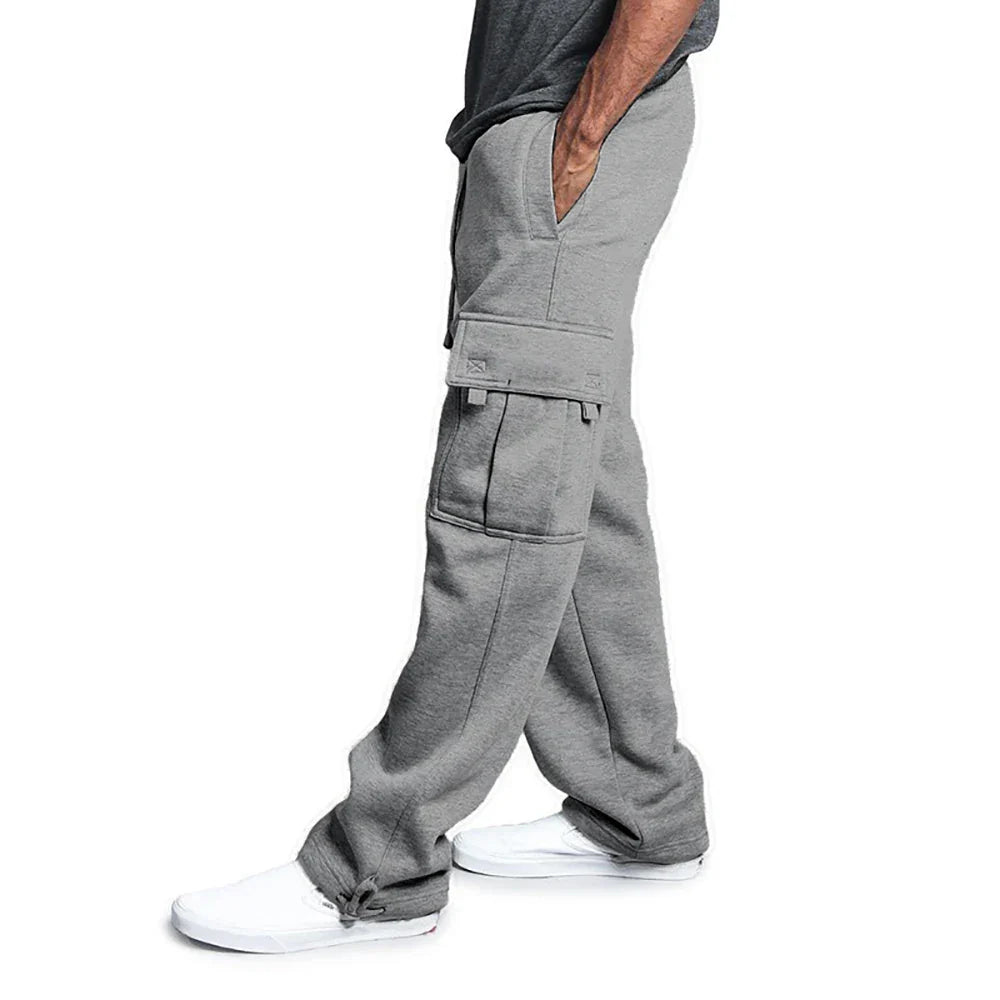 Person wearing gray cargo pants on a white background
