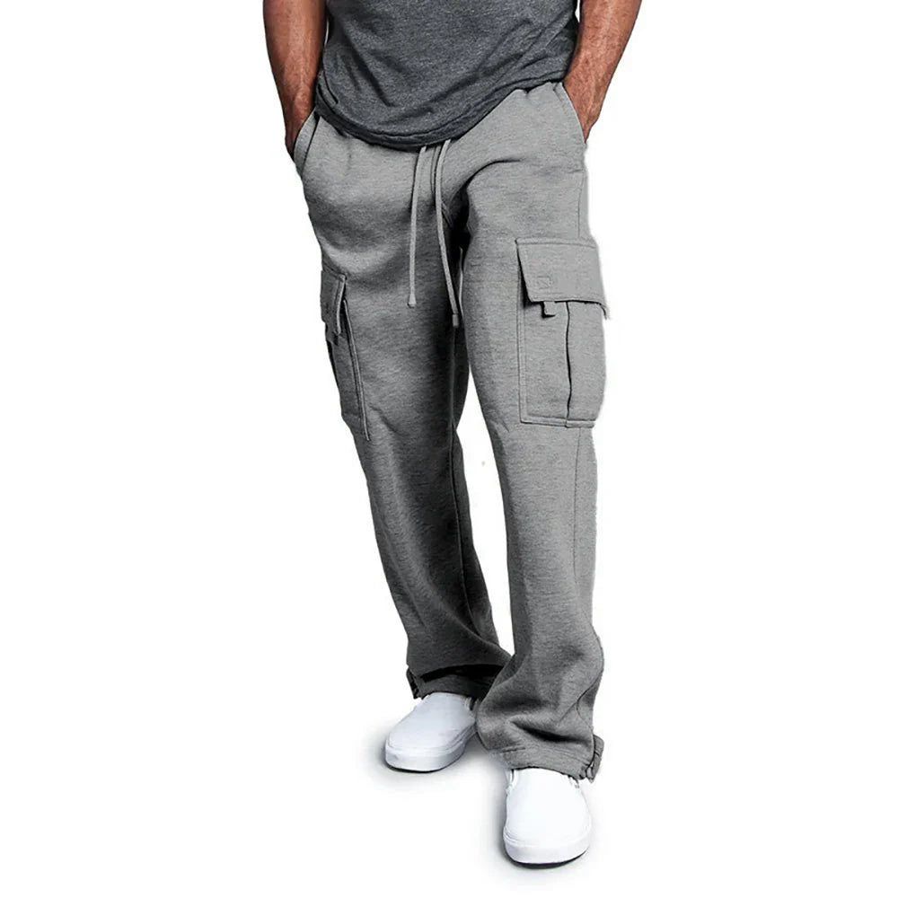 Person wearing gray cargo pants on a white background