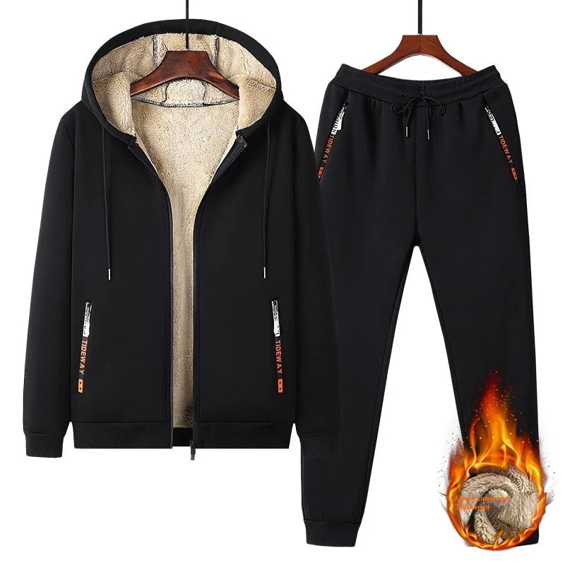 Black tracksuit with flame design on pants, on hangers against a white background