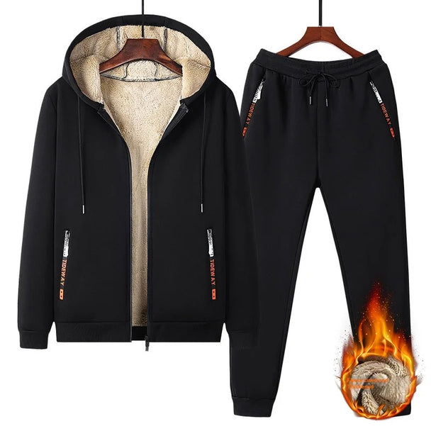 Black tracksuit with flame design on pants, on hangers against a white background