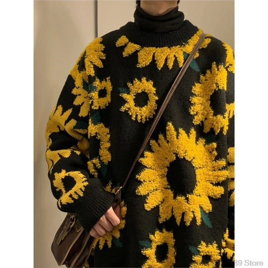 Black sweater with yellow sunflower patterns worn by a person.
