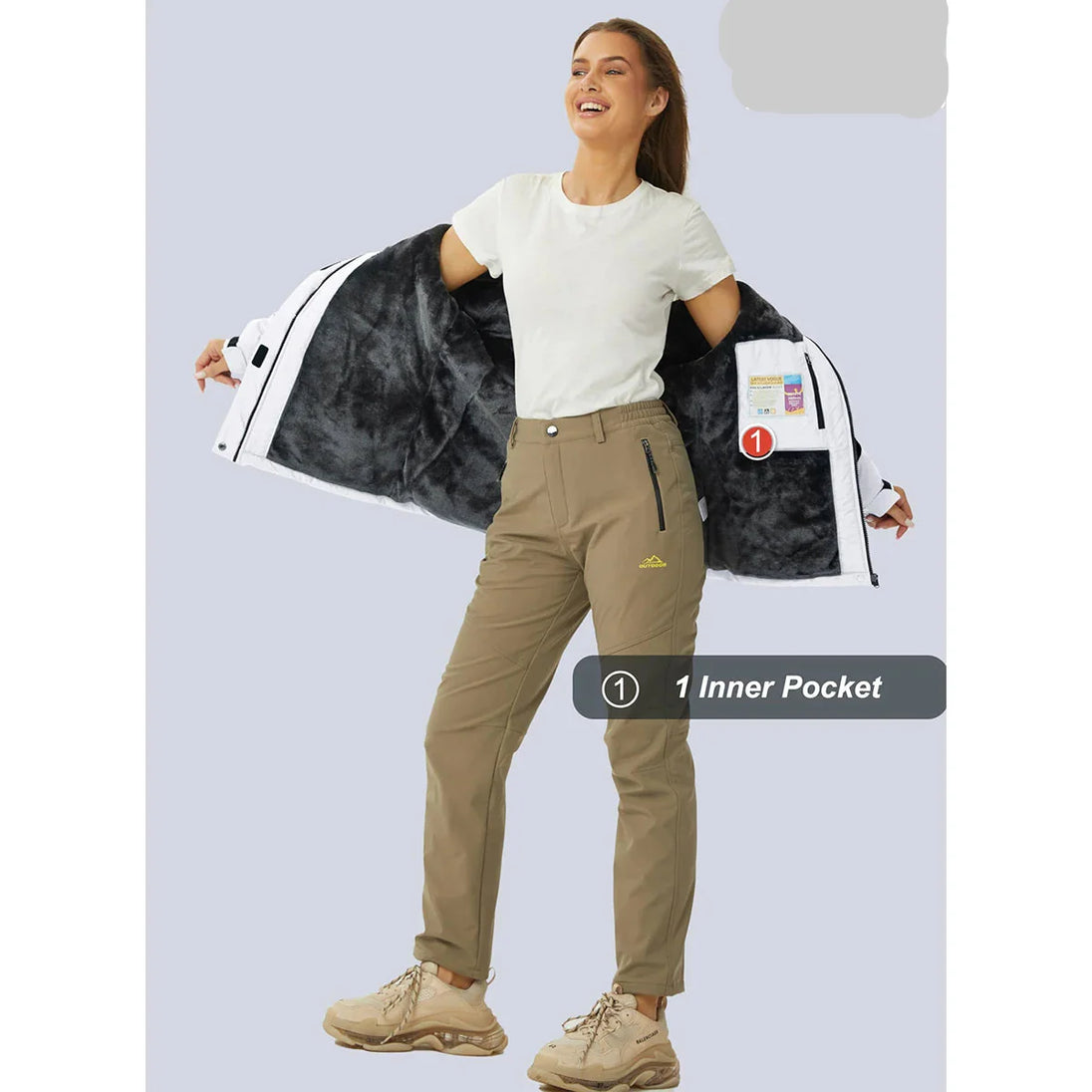 Woman holding a backpack with a visible inner pocket, wearing beige pants and a white shirt on a light gray background.